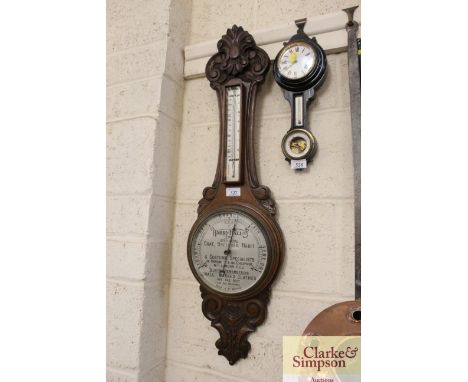 A late 19th / early 20th century carved banjo barometer the circular dial advertising Harry Hall Ltd. The Gold Medal Coat, Br