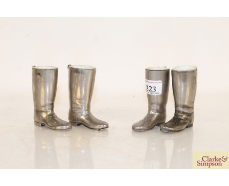 Two pairs of white metal miniature boots with china interiors (possibly trinket holders), 3¼" high 