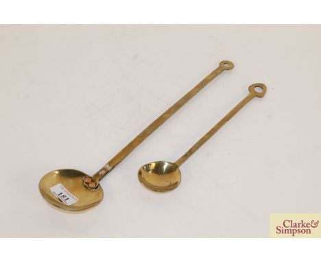 An antique brass ladle and a smaller similar