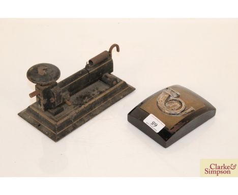 A wooden mounted brass plaque with white metal horn No.71 and a vintage cast iron stapler