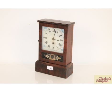 An American mantel clock with white painted Roman Numeral dial and decorative glass panel, 12" high