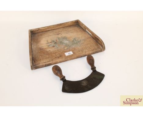A vintage wooden chopping board and a steel twin handled chopper