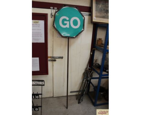 A vintage "Stop and Go" sign