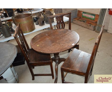 An antique elm tripod table and three country Chippendale style elm solid seated chairs