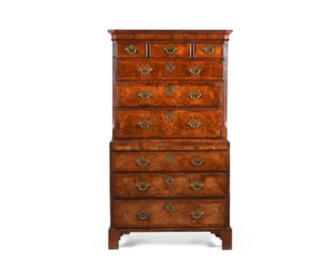 A GEORGE I FIGURED WALNUT AND FEATHER BANDED CHEST ON CHEST CIRCA 1720 Fitted with a brushing slide, the drawer fronts with f