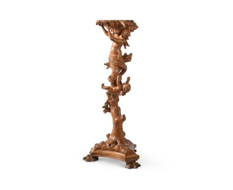 AN ITALIAN CARVED AND STAINED WOOD TRIPOD BASIN OR PLANT STAND BY VINCENZO CADORIN,LATE 19TH CENTURY The shell bowl supported