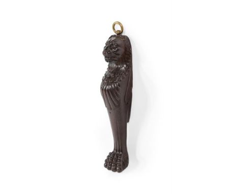 AN UNUSUAL CARVED MAHOGANY AND BRASS MOUNTED DOOR PORTER  FIRST HALF 19TH CENTURY  Formed from a Regency lion monopodia  64cm
