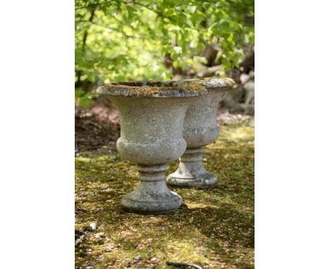 A PAIR OF STONE COMPOSITION CAMPANA URNS 20TH CENTURY each 53cm high, the tops 46cm diameter  Condition Report:  With weather