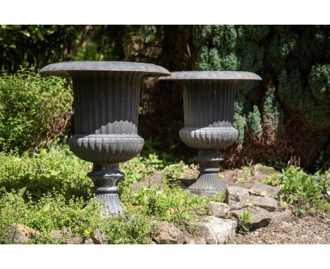 A PAIR OF VICTORIAN CAST IRON URNS  IN THE MANNER OF THE HANDYSIDE FOUNDRY, LATE 19TH CENTURY  each approximately 101cm high,