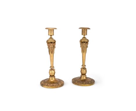 A PAIR OF BALTIC CANDLESTICKS LATE 19TH CENTURY, AFTER THE EARLY 19TH CENTURY RUSSIAN EMPIRE MODEL Each in gilt metal with ch