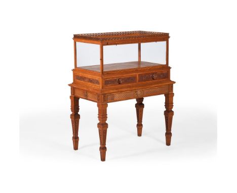 A VICTORIAN CARVED SATINWOOD DISPLAY CABINET ON STAND BY THOMAS HENRY KENDALL, LATE 19TH CENTURY Carved to all sides, with tw