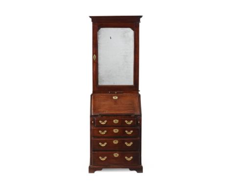 A GEORGE II MAHOGANY BUREAU BOOKCASE CIRCA 1750 The upper section with a re-entrant mirror inset cupboard door opening to adj