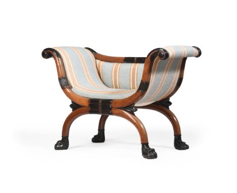 A GEORGE III MAHOGANY AND EBONISED WINDOW SEAT IN THE MANNER OF THOMAS HOPE, CIRCA 1810 Upholstered in striped woven linen ty
