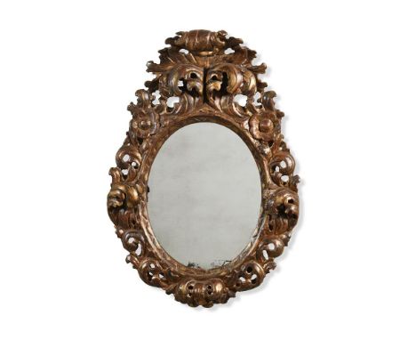 A CONTINENTAL CARVED GILTWOOD MIRROR  POSSIBLY ITALIAN, FIRST HALF 18TH CENTURY 78cm high, 54cm wide