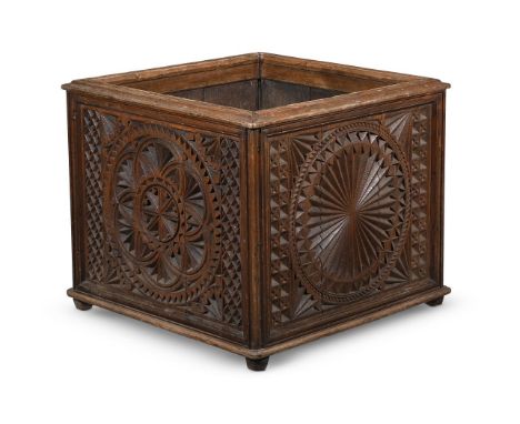 A LARGE 'COUNTRY HOUSE' CARVED HARDWOOD AND LEAD LINED LOG BIN OR PLANTER LATE 19TH CENTURY In Gothic Revival taste, with car