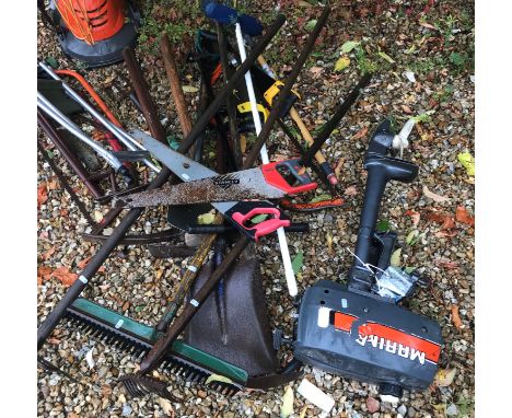 An outboard motor and collection of garden hand tools to include pickaxes, etc