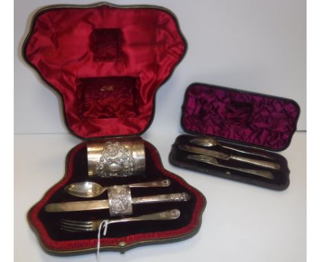 A late Victorian silver Christening set comprising mug, spoon, fork, knife and napkin ring, the mug and napkin ring with embo