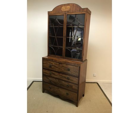 A Regency mahogany secretaire bookcase, the domed cornice with inlaid elongated octagonal panel over a pair of glazed doors e