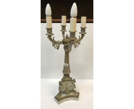 A pair of 20th Century brass four light table lamps in the Empire style, with scrolling foliate and fluted decoration on a li