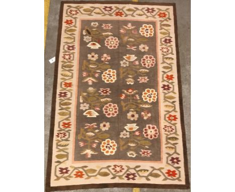 A Kelim rug, the central panel set with floral sprays on a mushroom ground, within a stepped border, approx 129 cm x 193 cm, 