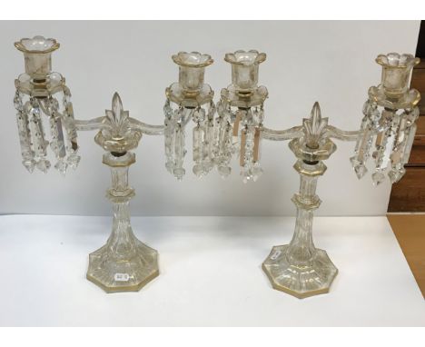 A pair of Continental etched and gilded octagonal glass table candelabra, the twin branch candle holders with lustre drops on