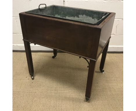 A 19th Century mahogany and cross-banded jardinier, the top with moulded edge, raised on square supports with brass C scroll 