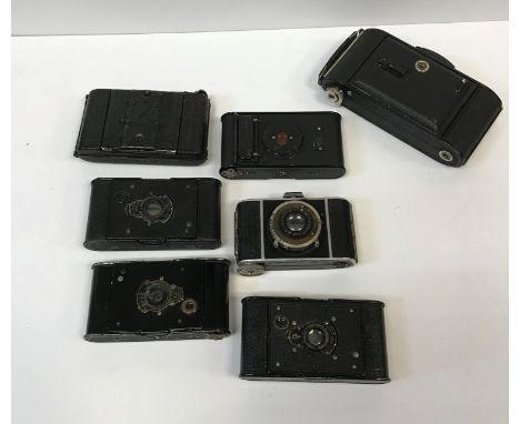 A collection of eight various cameras including a Voigtländer 6M bellows camera, Kodak VP Autographic camera, Eastman Kodak V