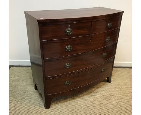 A 19th Century mahogany bow fronted chest of two short over three long graduated drawers with urn decorated brass wreath drop