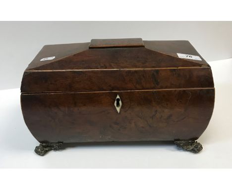 A 19th Century burr yew tea caddy of sarcophagus form, the top opening to reveal a central mixing bowl recess, flanked by two