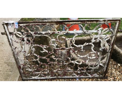 A painted wrought iron panel with scrolling decoration set with armorial crest to centre, housed in a later frame set as a ga