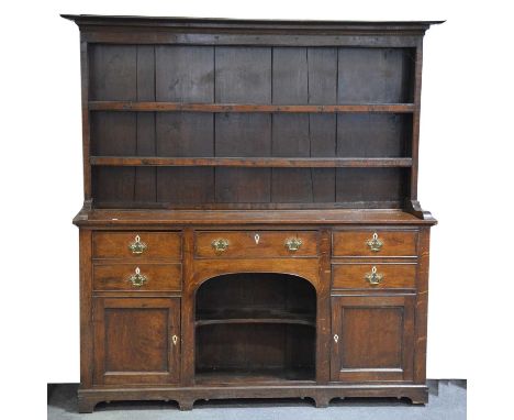George III oak dresser, moulded cornice, the back with two fixed shelves, base with five drawers and two cupboards around an 