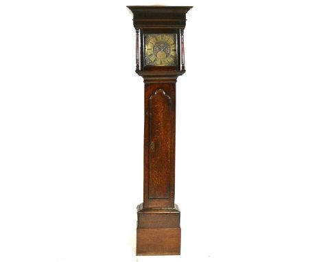Early oak longcase clock, hood with moulded cornice and turned columns, trunk with long arched door, ten inch square brass di