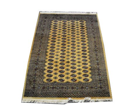 Bokhara carpet, four rows of twenty guls on an old gold ground, multi-bordered, 270 x 190cm.