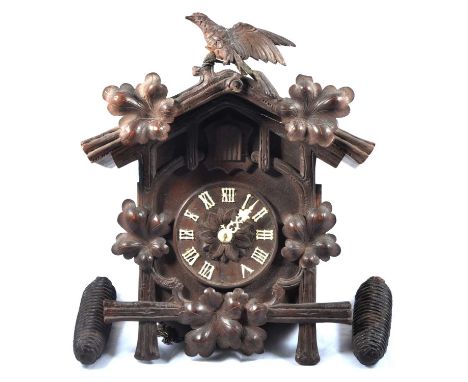 Black Forest type cuckoo clock, weight-driven movement, carved case, 38cm.Condition report:One side of bellows is damaged, no