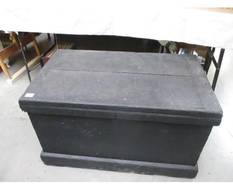 A heavy black painted wooden tool chest