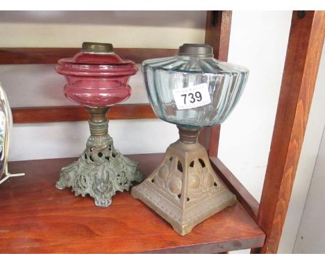 A Victorian cranberry glass oil lamp and 1 other - both missing burners