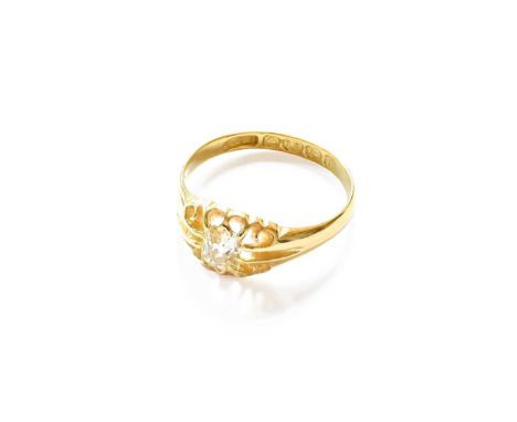 An 18 Carat Gold Diamond Solitaire Ring, the old cut diamond in a yellow claw setting, to a plain polished shank, finger size