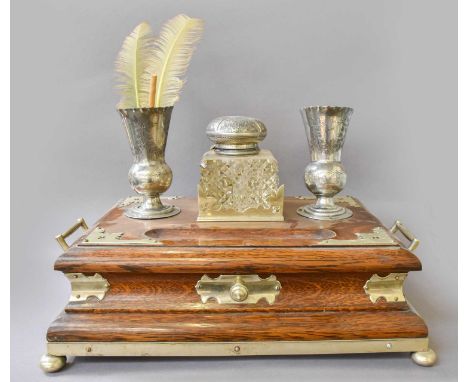 An Oak Deskstand With Silver Plated Mounts, circa 1900, incorporating an inkwell, pair of vases and a drawer, 44cm wide