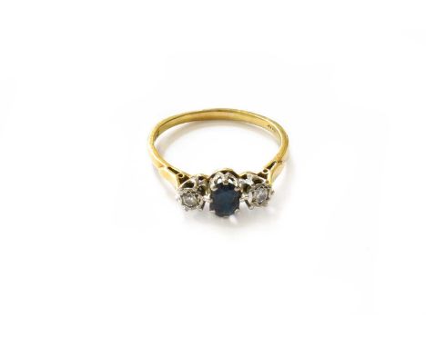 An 18 Carat Gold Sapphire and Diamond Three Stone Ring, the oval cut sapphire flanked by round brilliant cut diamonds, in whi