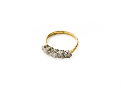 An 18 Carat Gold Diamond Five Stone Ring, the graduated old cut diamonds in white rubbed over settings, to a yellow tapered s