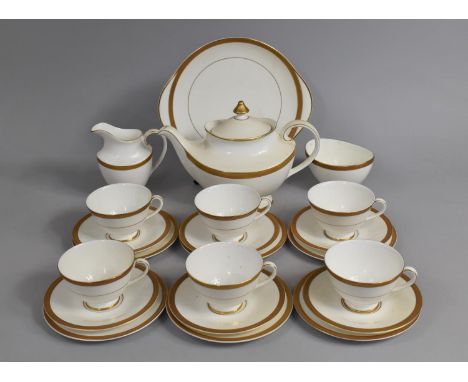 A Royal Doulton "Royal Gold" Tea Service to comprise Teapot, Milk Jug, Sugar Bowl, Six Cups, Saucers, Side Plates and a Cake 