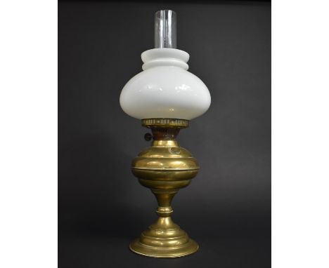 A Brass Oil Lamp with Opaque Glass Shade and Plain Glass Chimney, 53cms High 