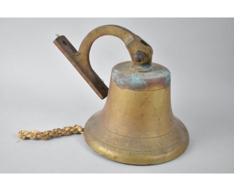 A Vintage Brass Wall Mounting Bell, 19cms High 