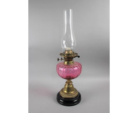 A Late 19th Century Brass Based Oil Lamp with Cranberry Glass Reservoir, 55cm high