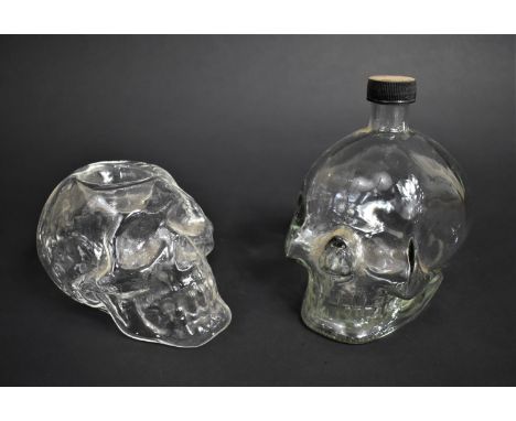 Two Moulded Glass Skulls, Bottle and Tea Light Holder, tallest 15.5cms High 