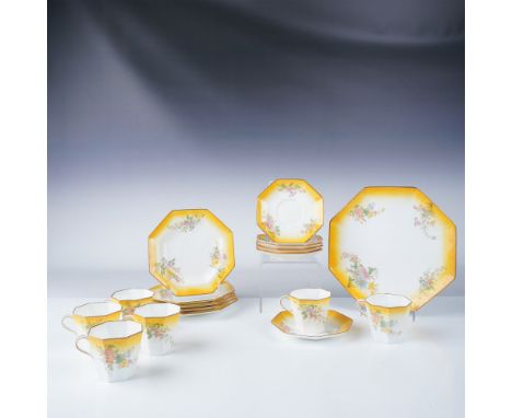 Elegant 18-piece Wedgwood porcelain tea set featuring a vibrant floral design with gold accents on a gradient yellow and whit