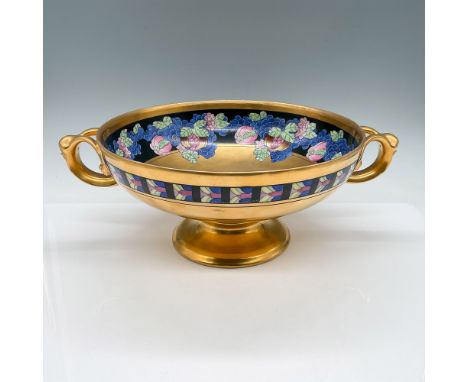 This stunning footed bowl, hand-painted by artist Emil Tolpin, features a vibrant and intricate design of gold grapes and pom