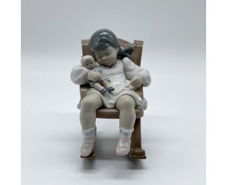 This charming Lladro porcelain figurine, titled "Naptime" (Item #01005448), was sculpted by José Puche and introduced in 1987