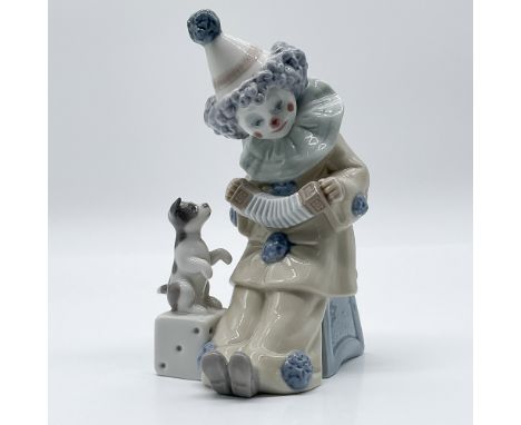 This Lladro porcelain figurine, "Pierrot with Concertina," is a charming representation of the classic Pierrot character. Scu
