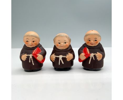 A collection of ceramic shakers, designed in the figure of Friar Tuck with a brown robe, and holding onto a red book. Goebel 